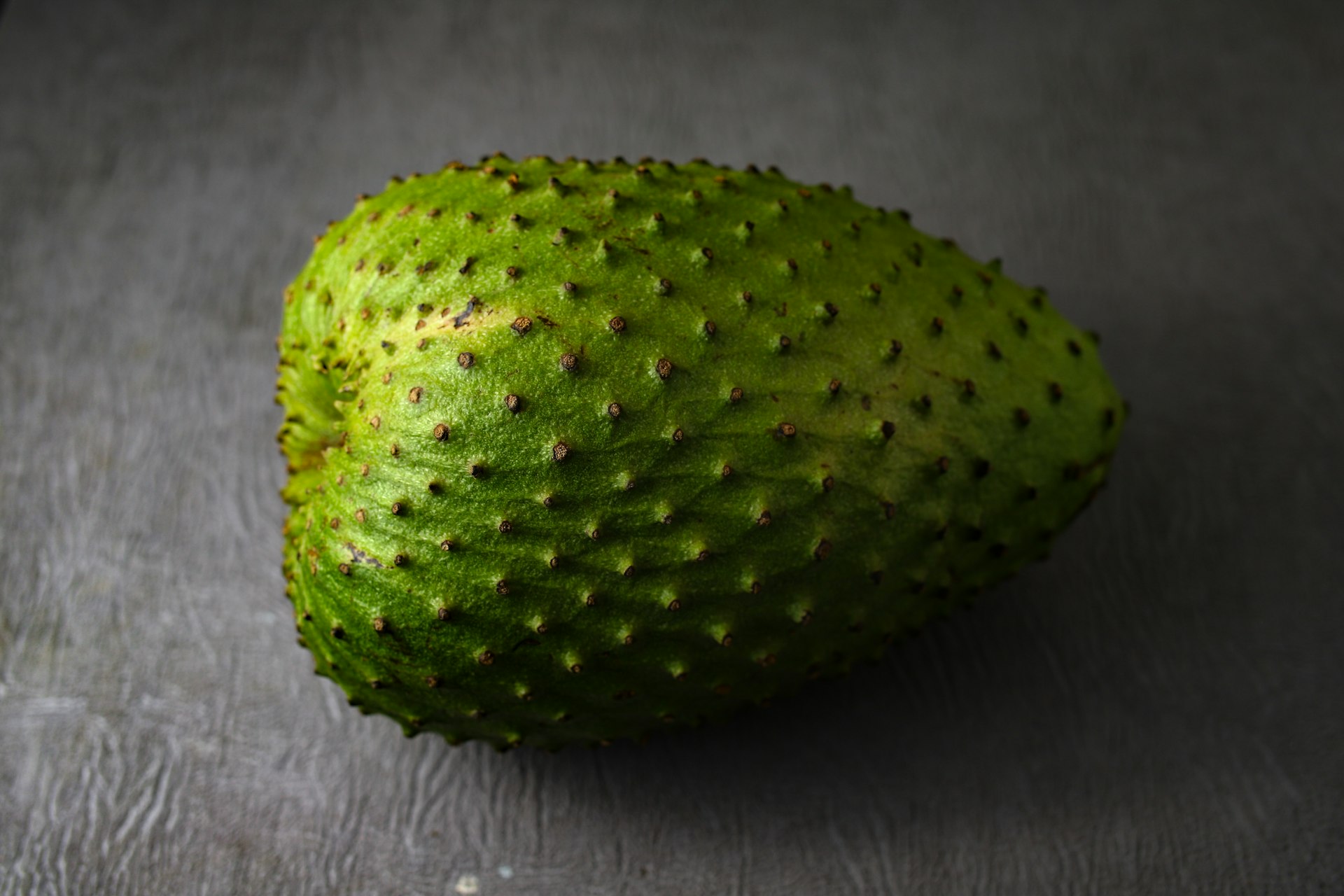 green round fruit on gray textile